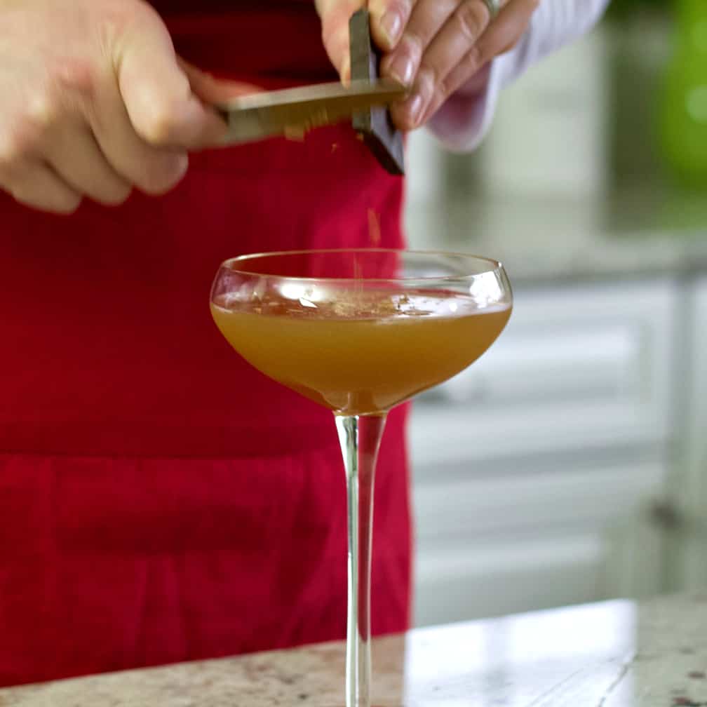 shaving chocolate over the top of the margarita