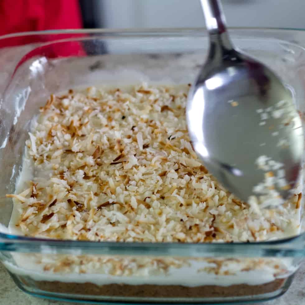 sprinkling toasted coconut over frosting
