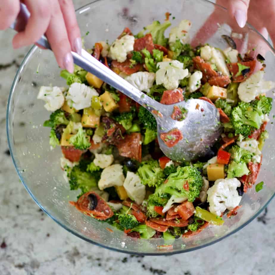 stirring broccoli cauliflower salad