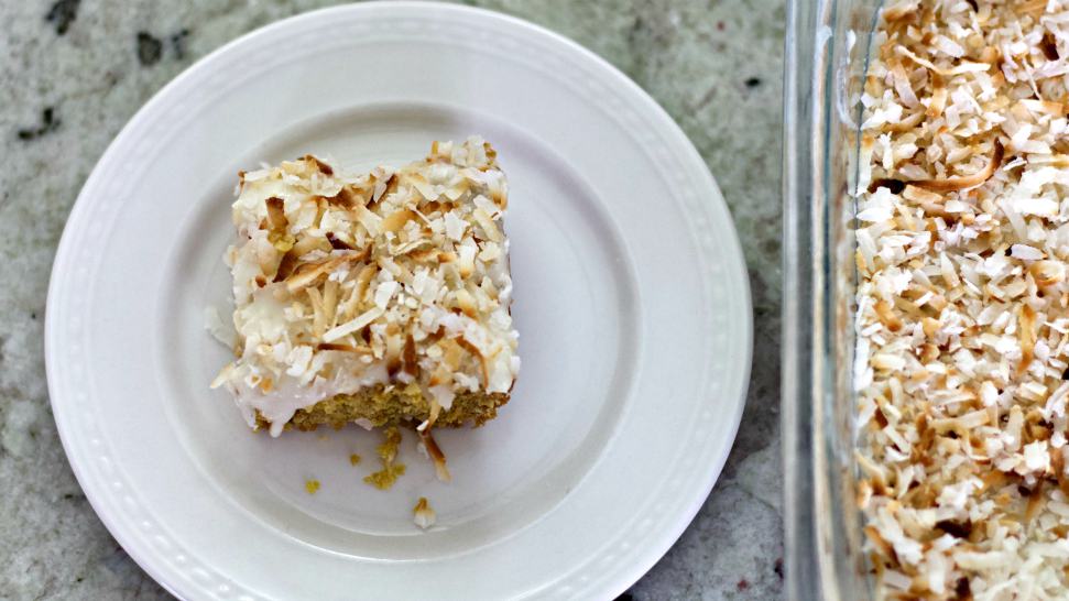 toasted coconut bars in pan and plate