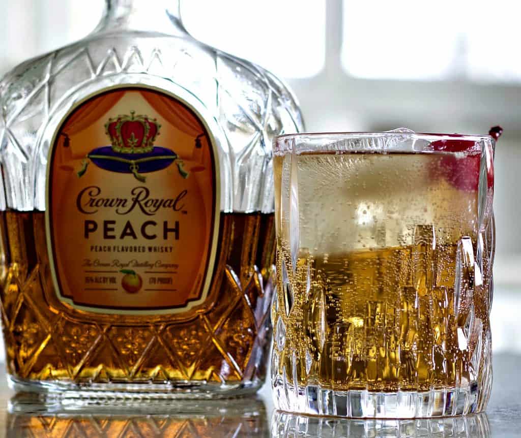 Crown royal peaches and cream cocktail with crown royal peach whiskey bottle