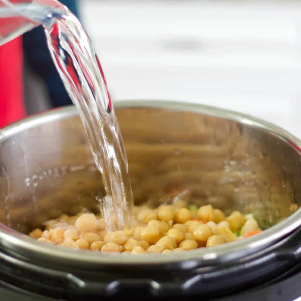pouring water into the cabbage beef stew