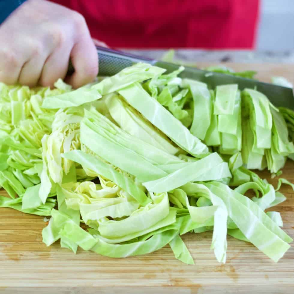 chopping green cabbage for cabbage beef stew