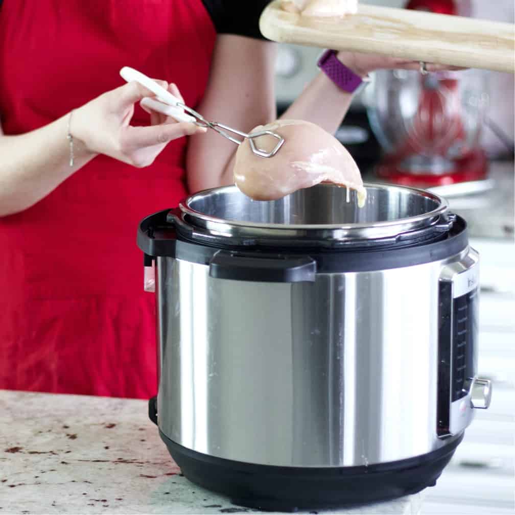 Placing chicken breasts into instant pot-chicken chili