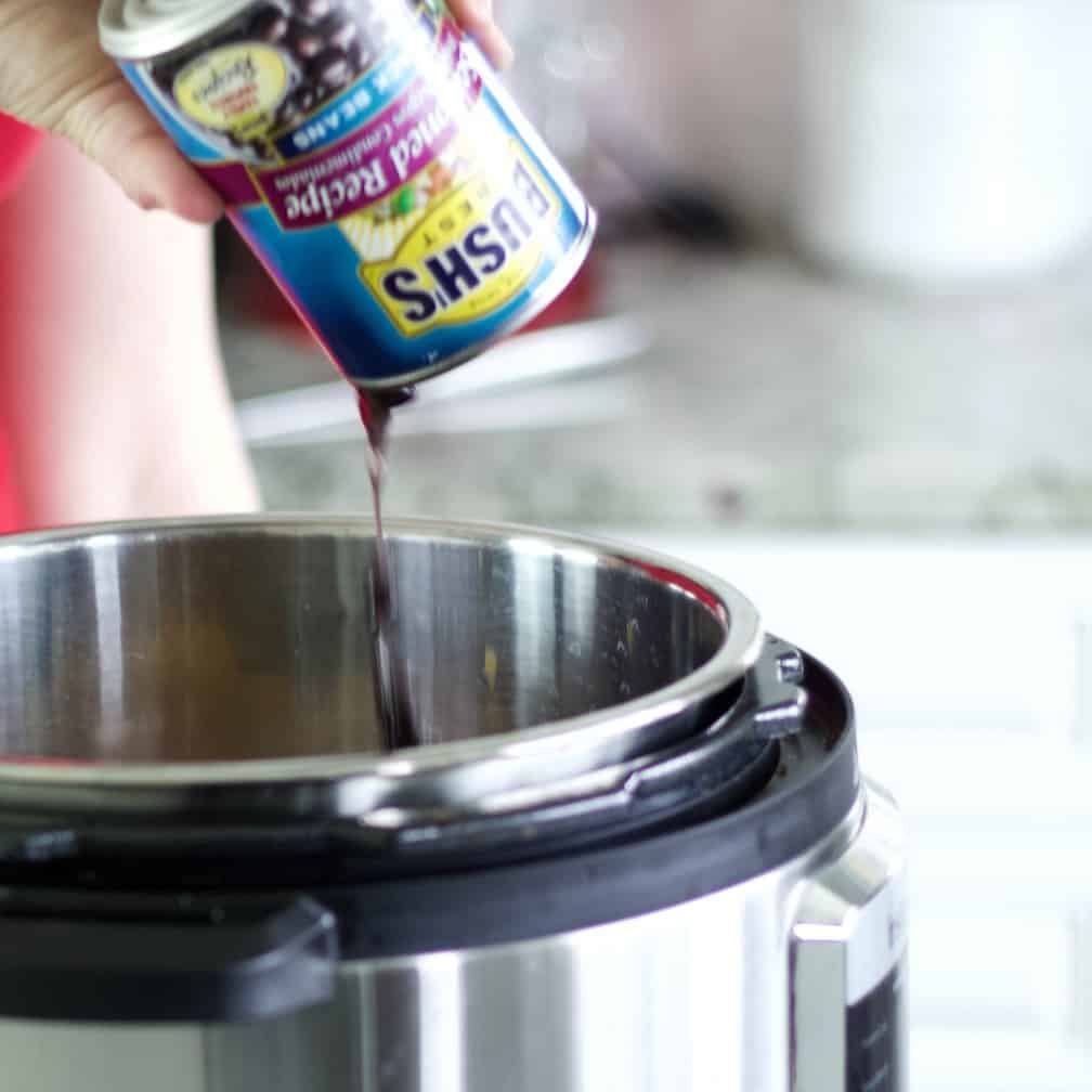pouring black beans into instant pot-chicken chili