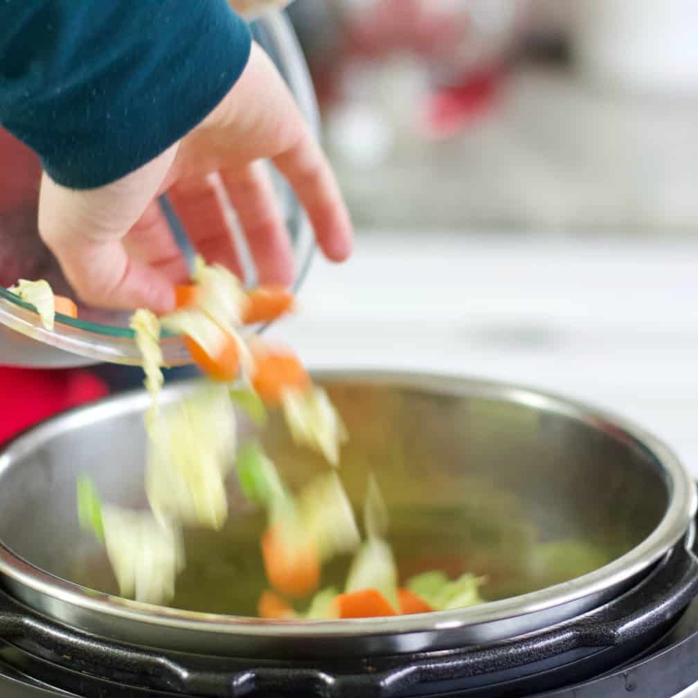 pouring vegetables into the instant pot-cabbage beef stew