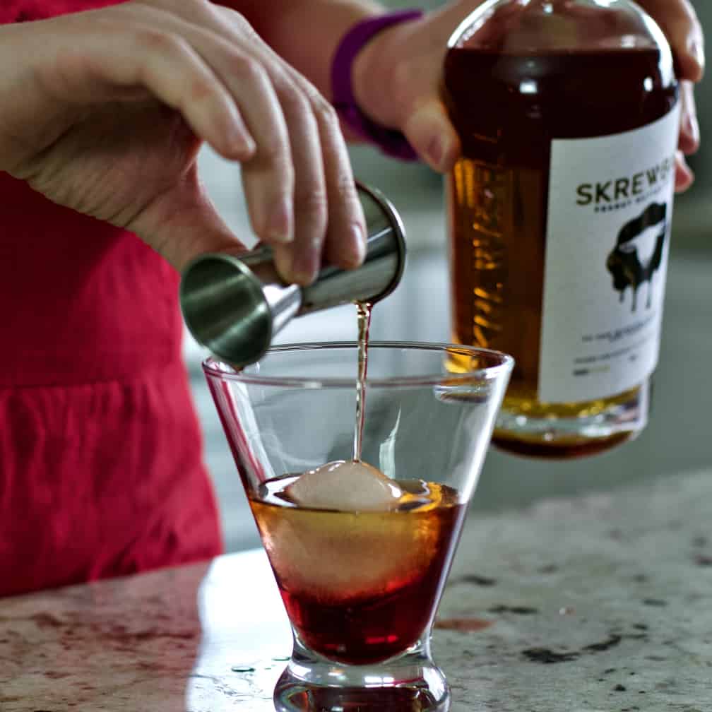 layering the peanut butter whiskey on top of chambord.