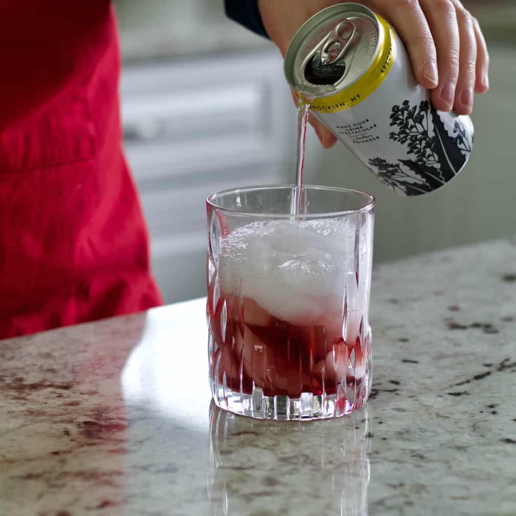 pouring tonic water in cocktail