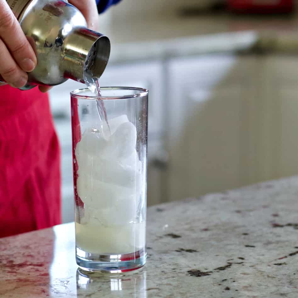Pour shaker contents over ice