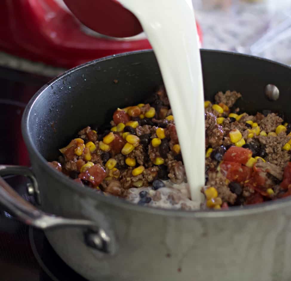 Pouring milk-taco hamburger dinner