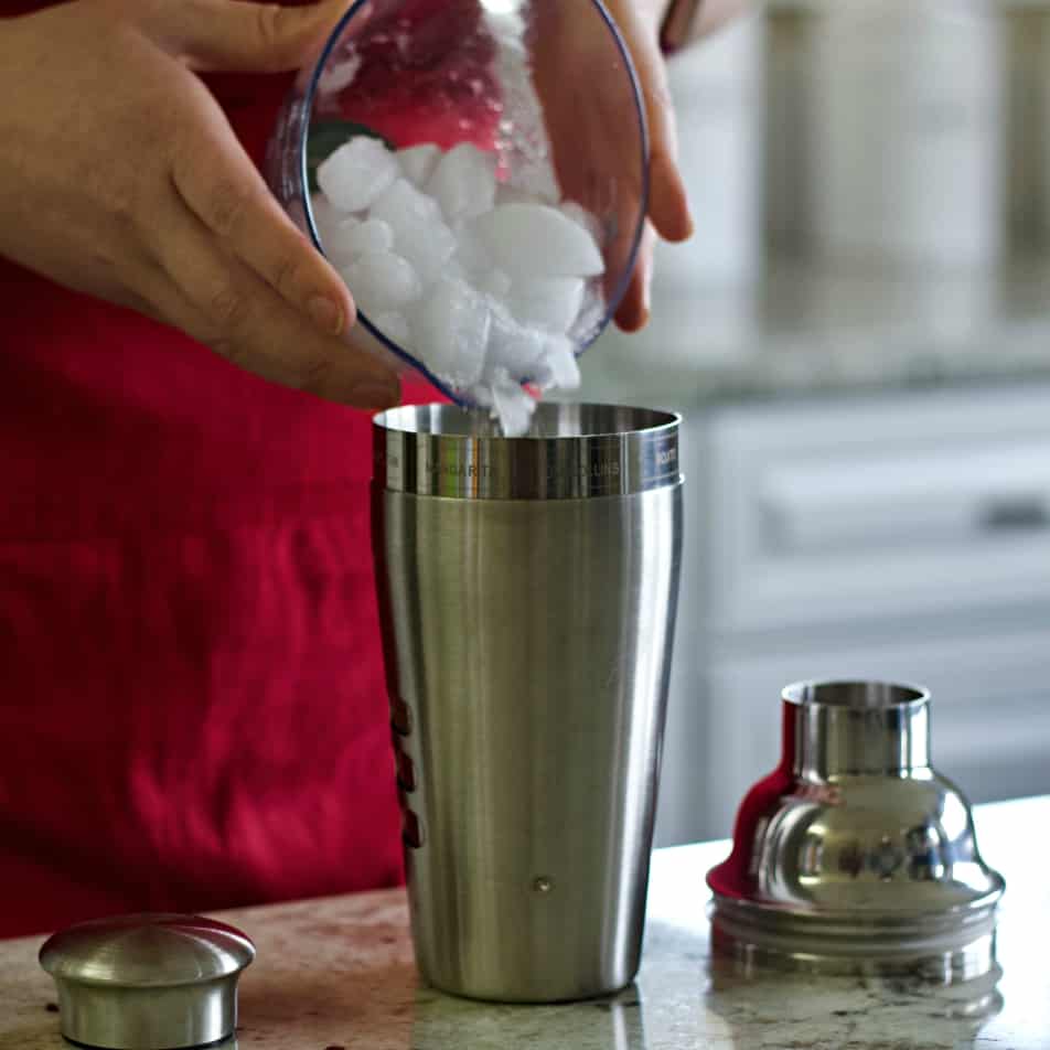 pouring ice into a shaker-Mezcal drink