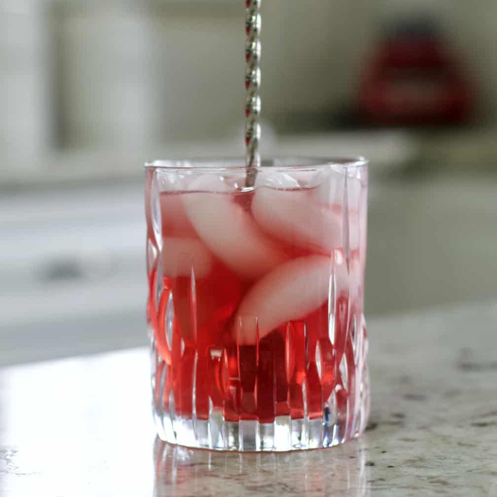 stirring the chambord cocktail