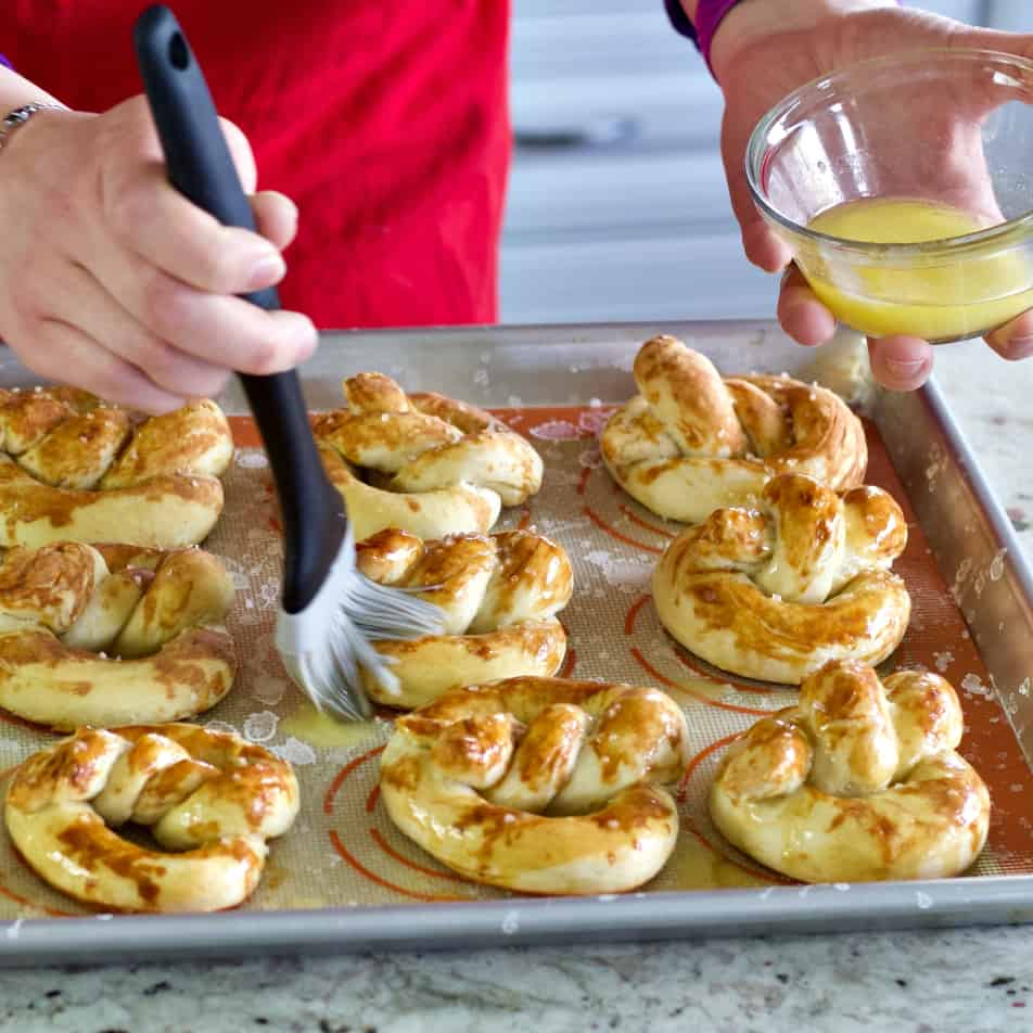 Brushing butter on pretzels