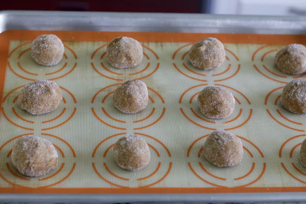 raw molasses cookies on tray.