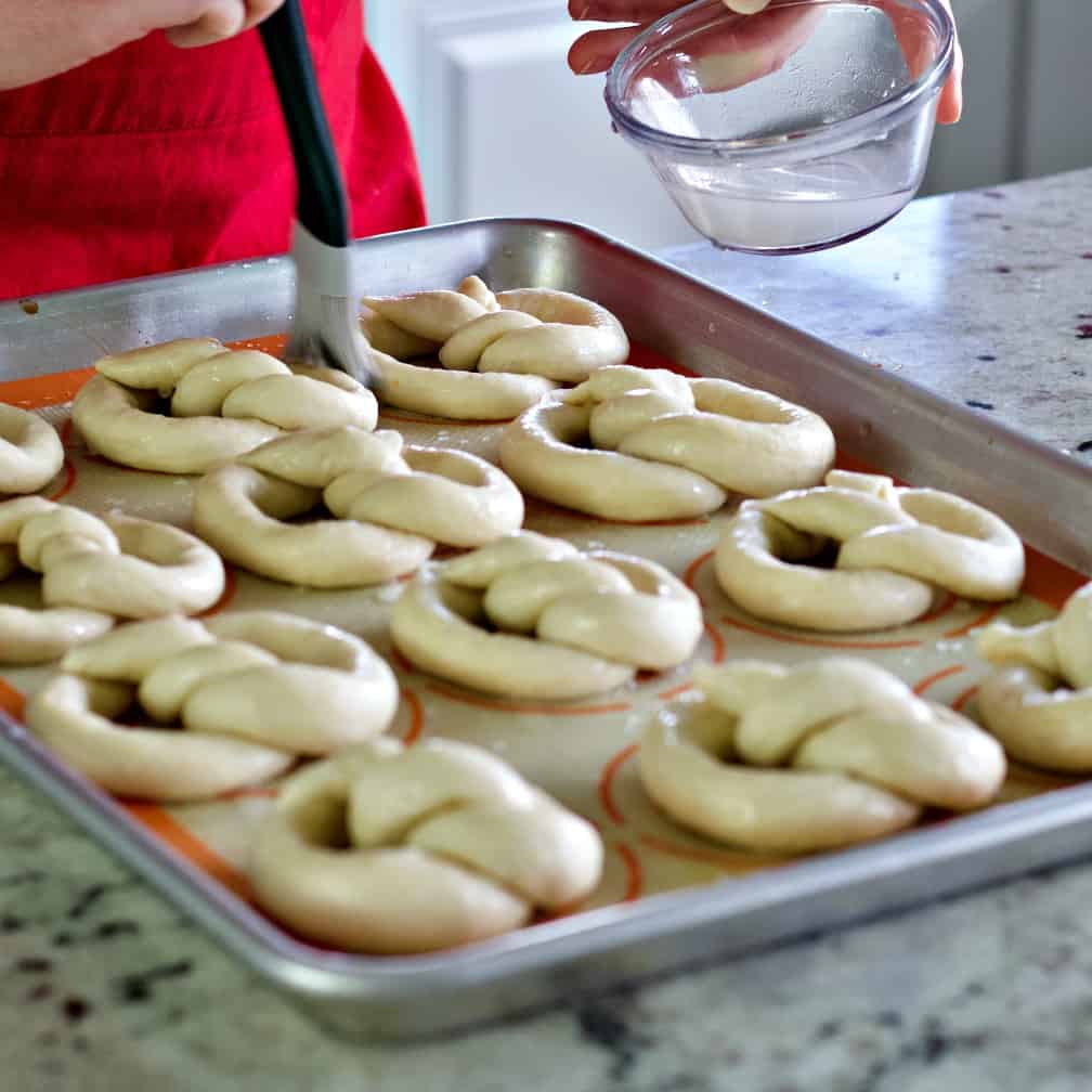 Brushing on baking soda wash-sourdough pretzels