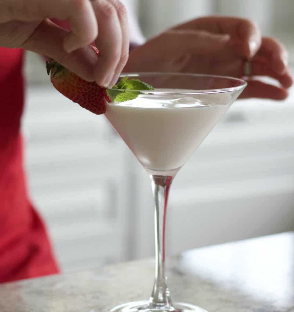 garnishing strawberries and cream cocktail
