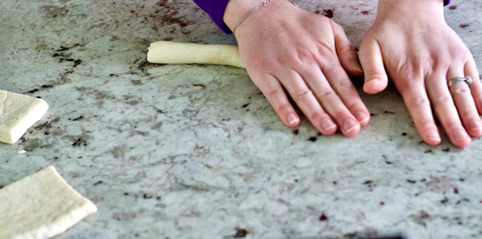 rolling pretzel dough ropes.
