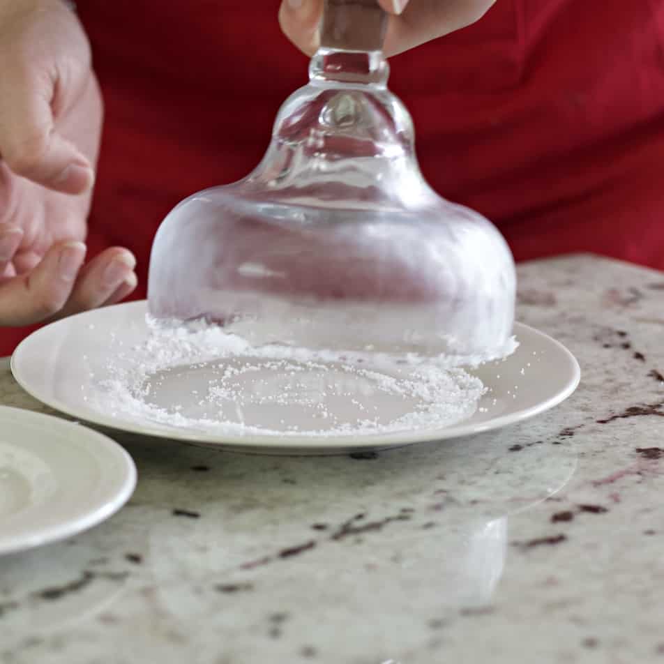 rolling a margarita glass in salt
