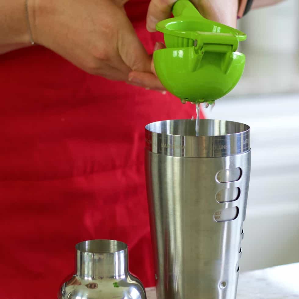 squeezing a lime-blue margarita recipe