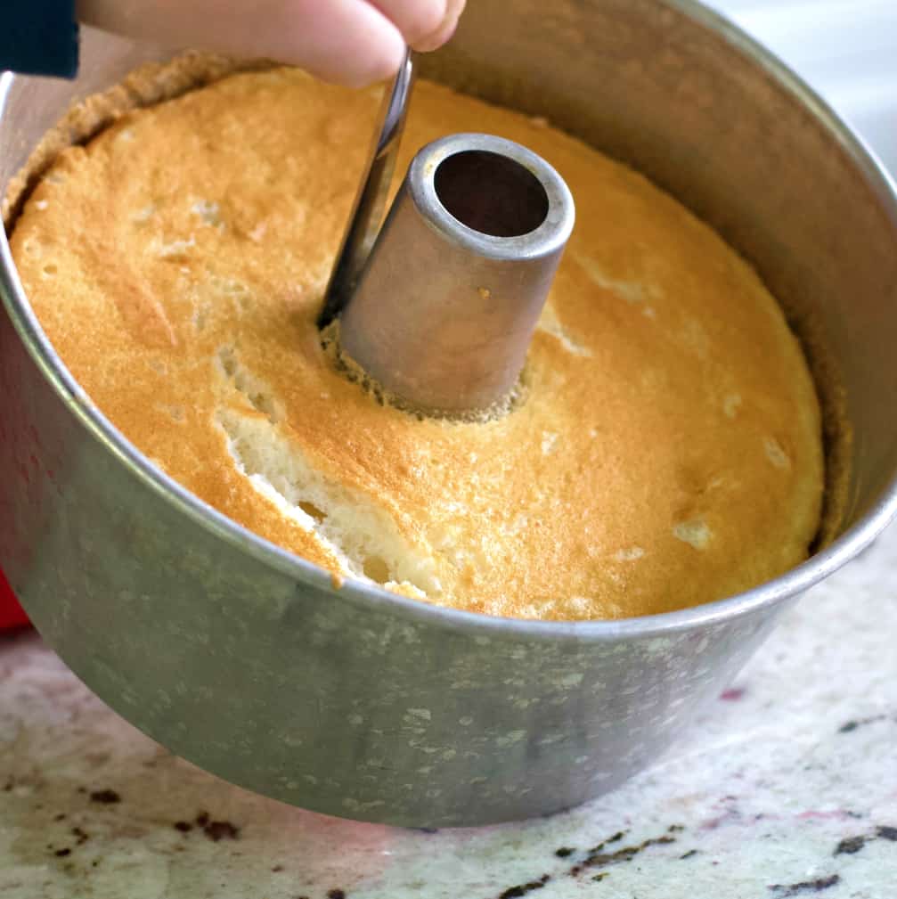 cutting the angel cake out of the pan.