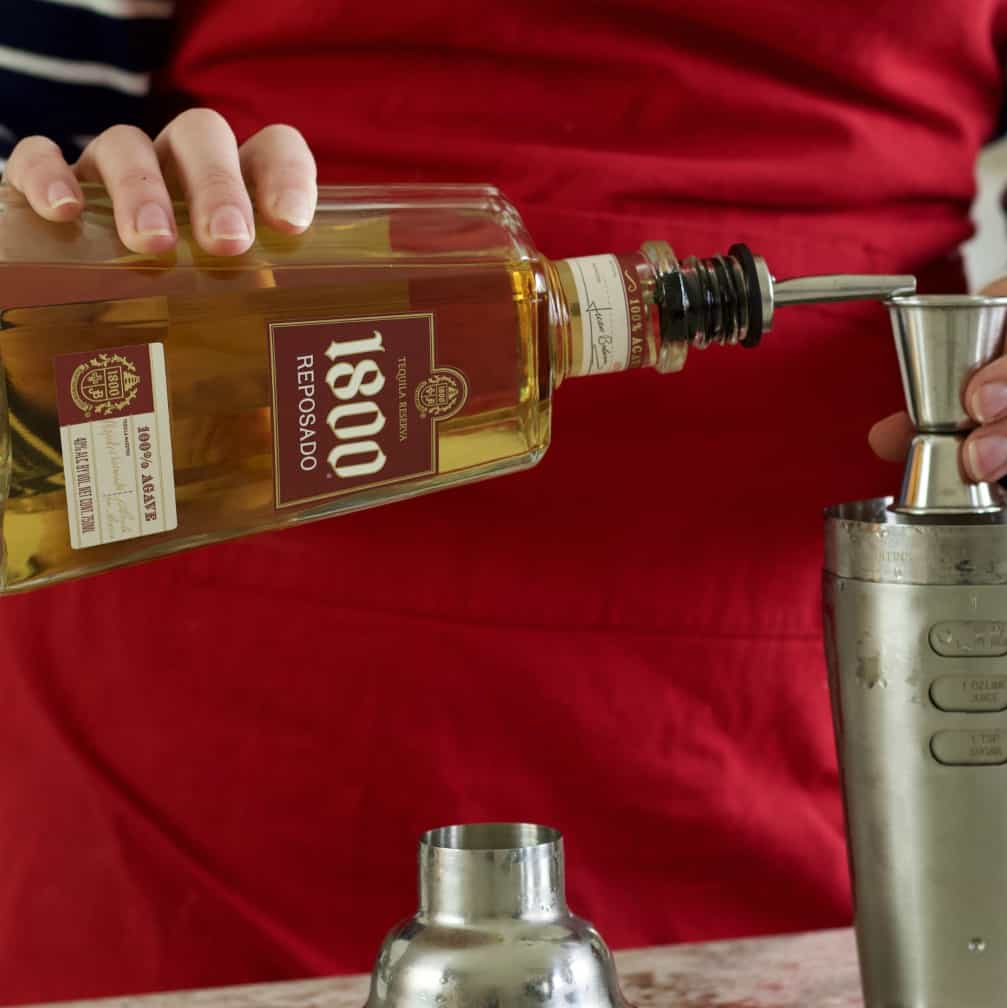 pouring 1800 reposado tequila