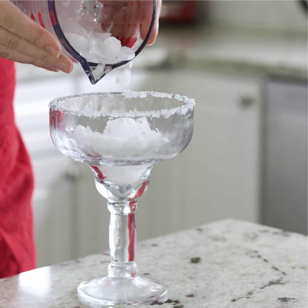 adding ice to margarita glass.