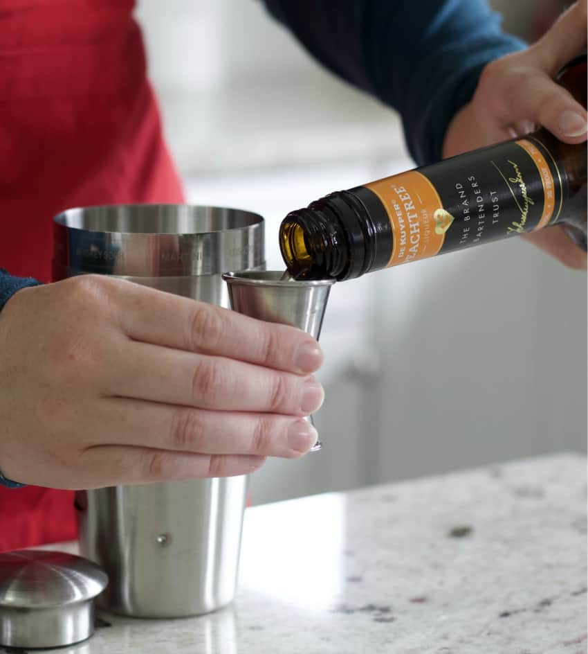 pouring peachtree liqueur