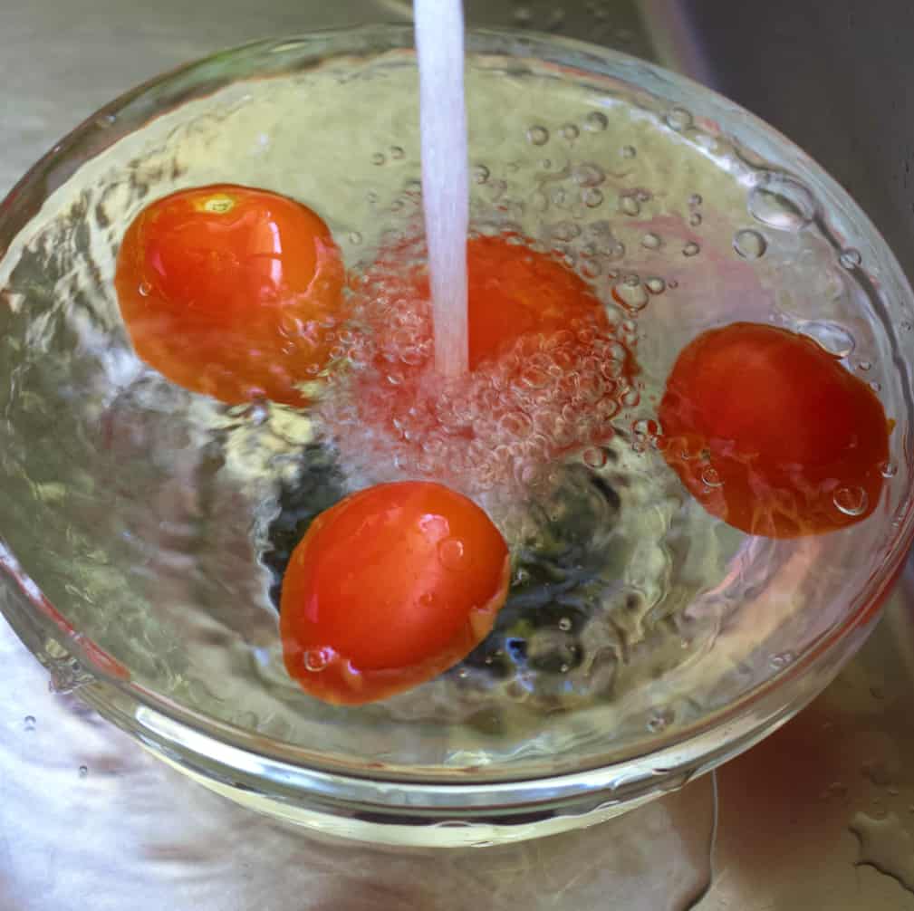 running frozen tomatoes under warm water