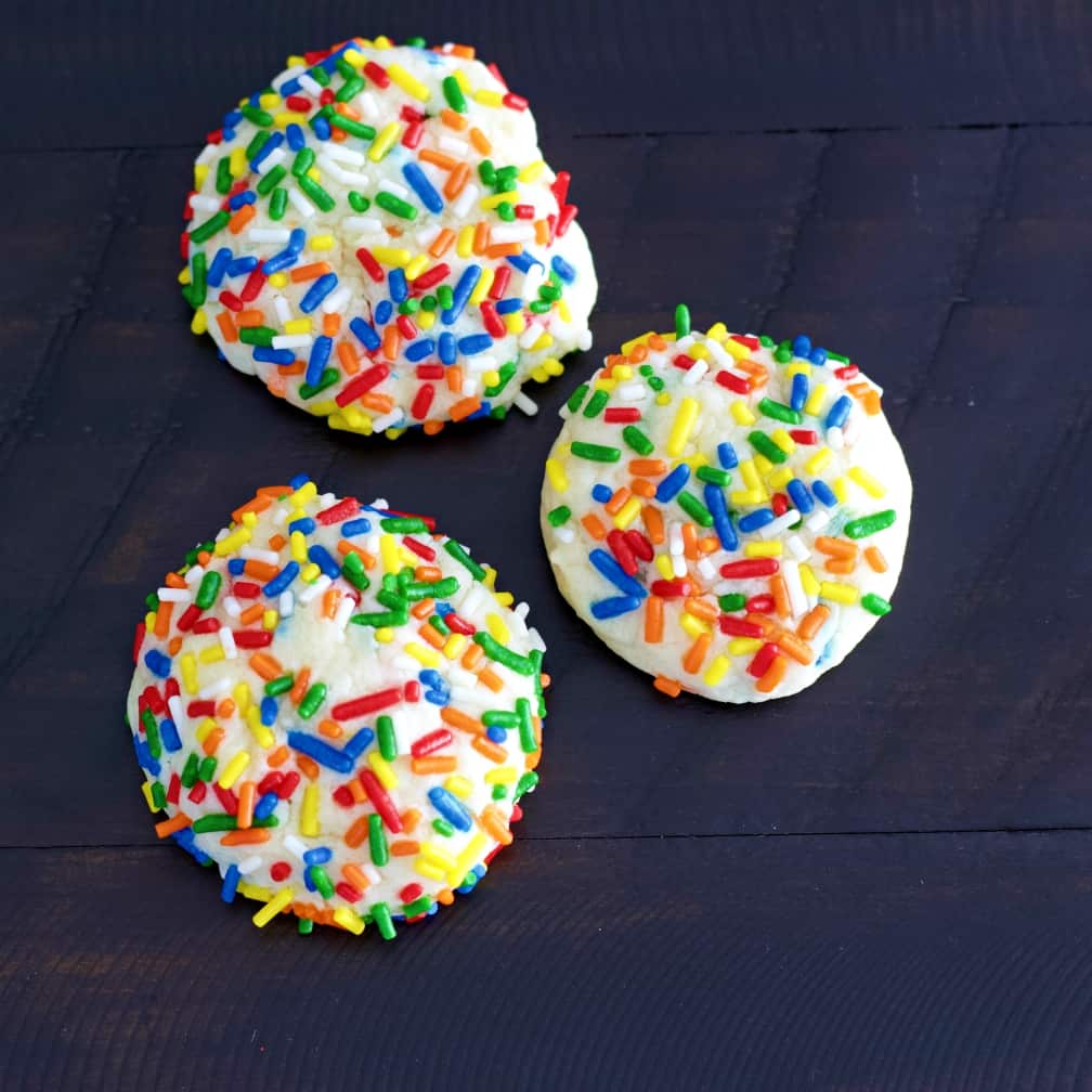 confetti sprinkle cookies on a dark table