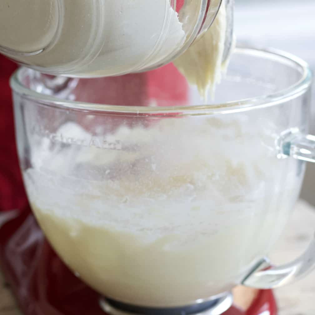 adding dry ingredients to mixer.