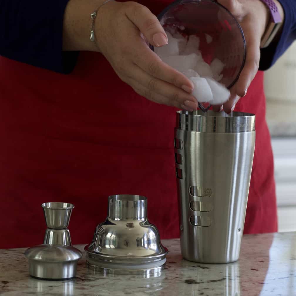 pouring ice into cocktail shaker