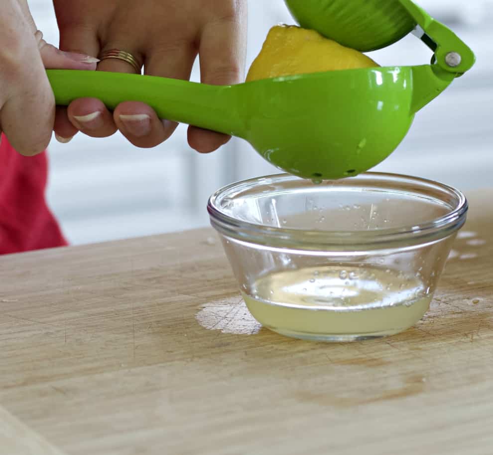 squeezing fresh lemon-lemon butter sauce