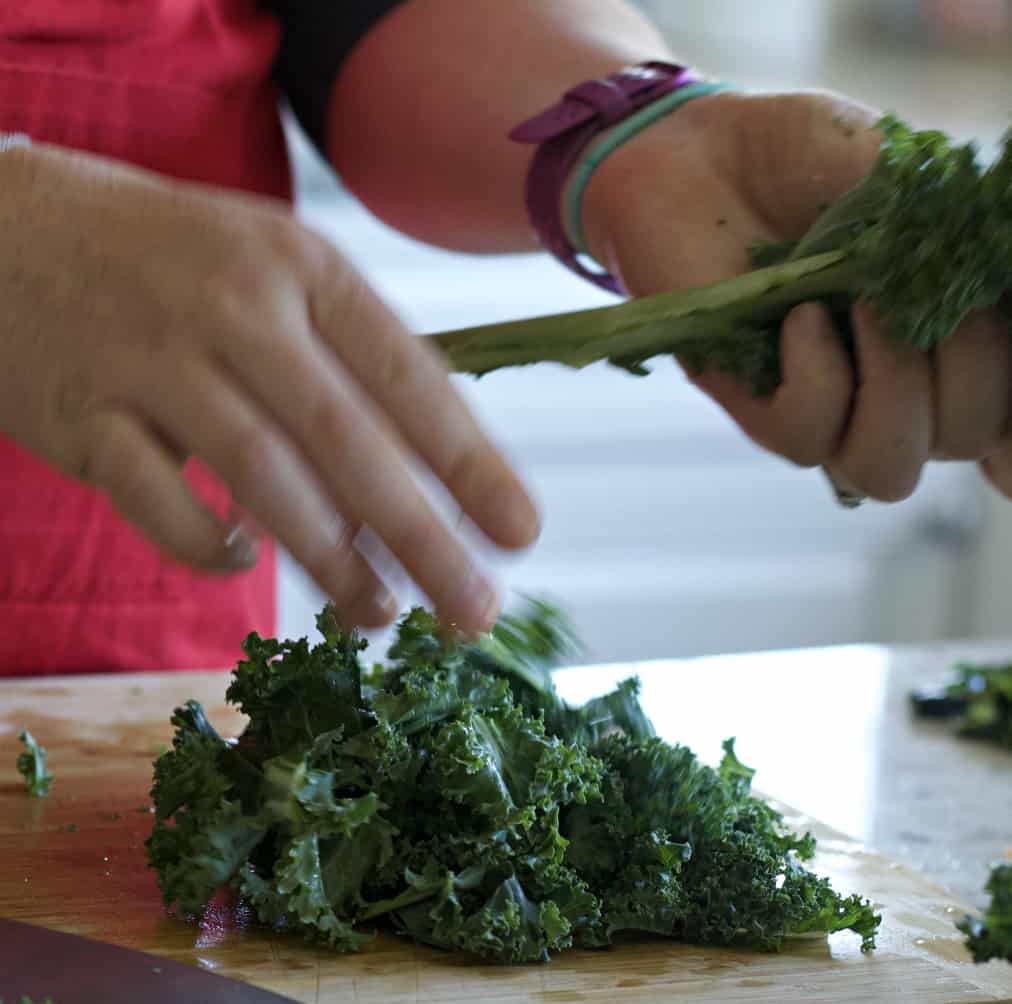 Instant Pot Lentil Soup Recipe 10 Stripping kale from the stalk.