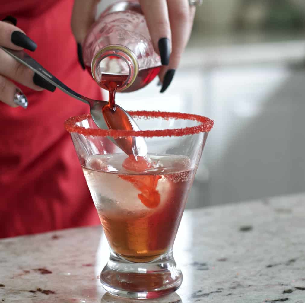 drizzling grenadine over spoon