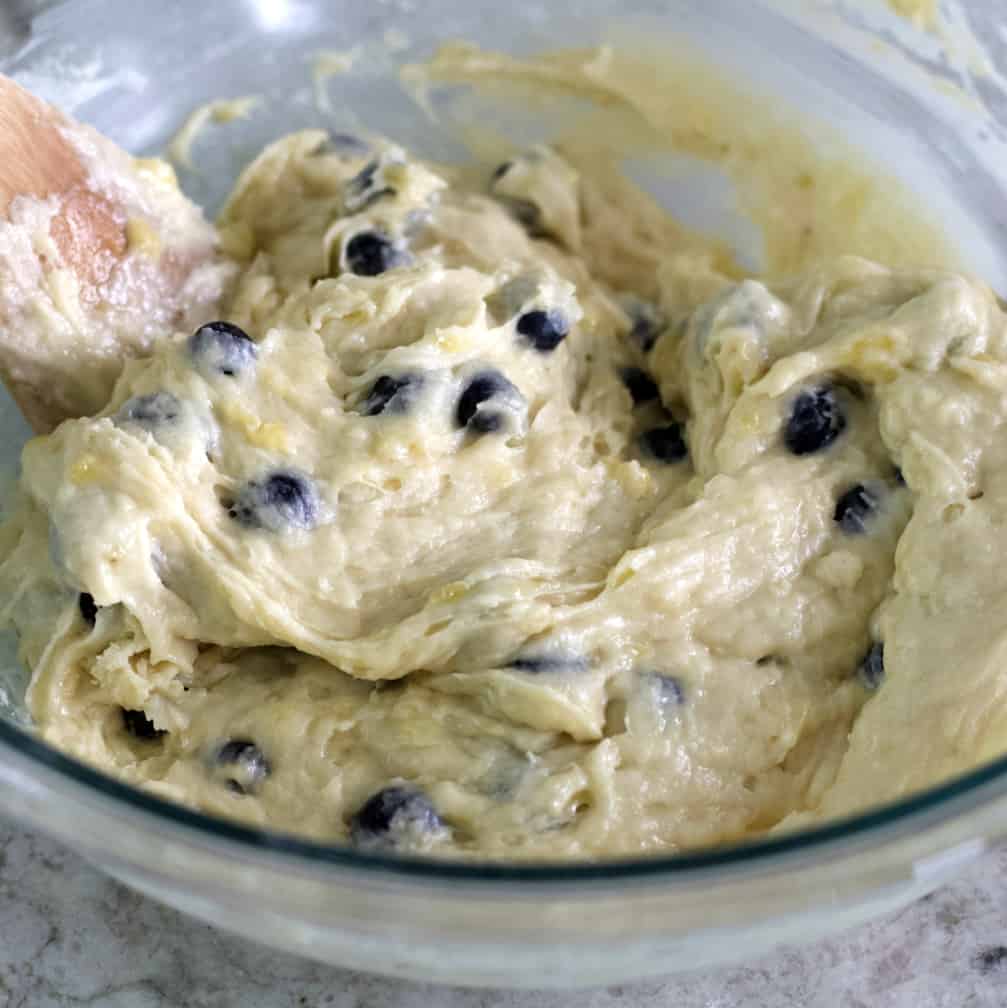 Incredible Banana Blueberry Muffins 17 stirring muffin batter with a wooden spoon