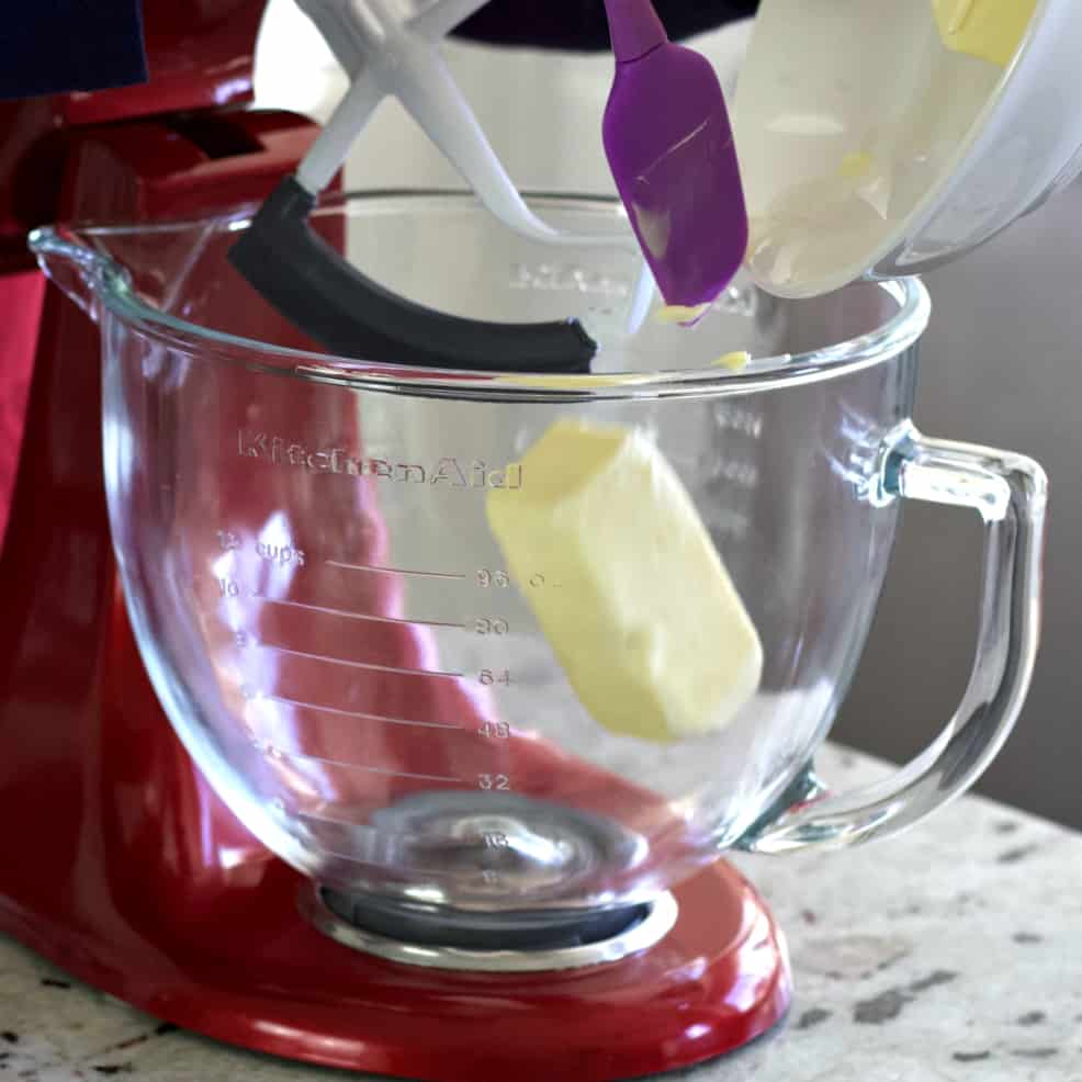 dumping butter into mixer bowl