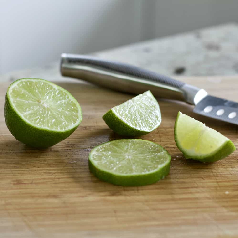 Cadillac Margarita Recipe with Grand Marnier 8 lime slices on wooden board