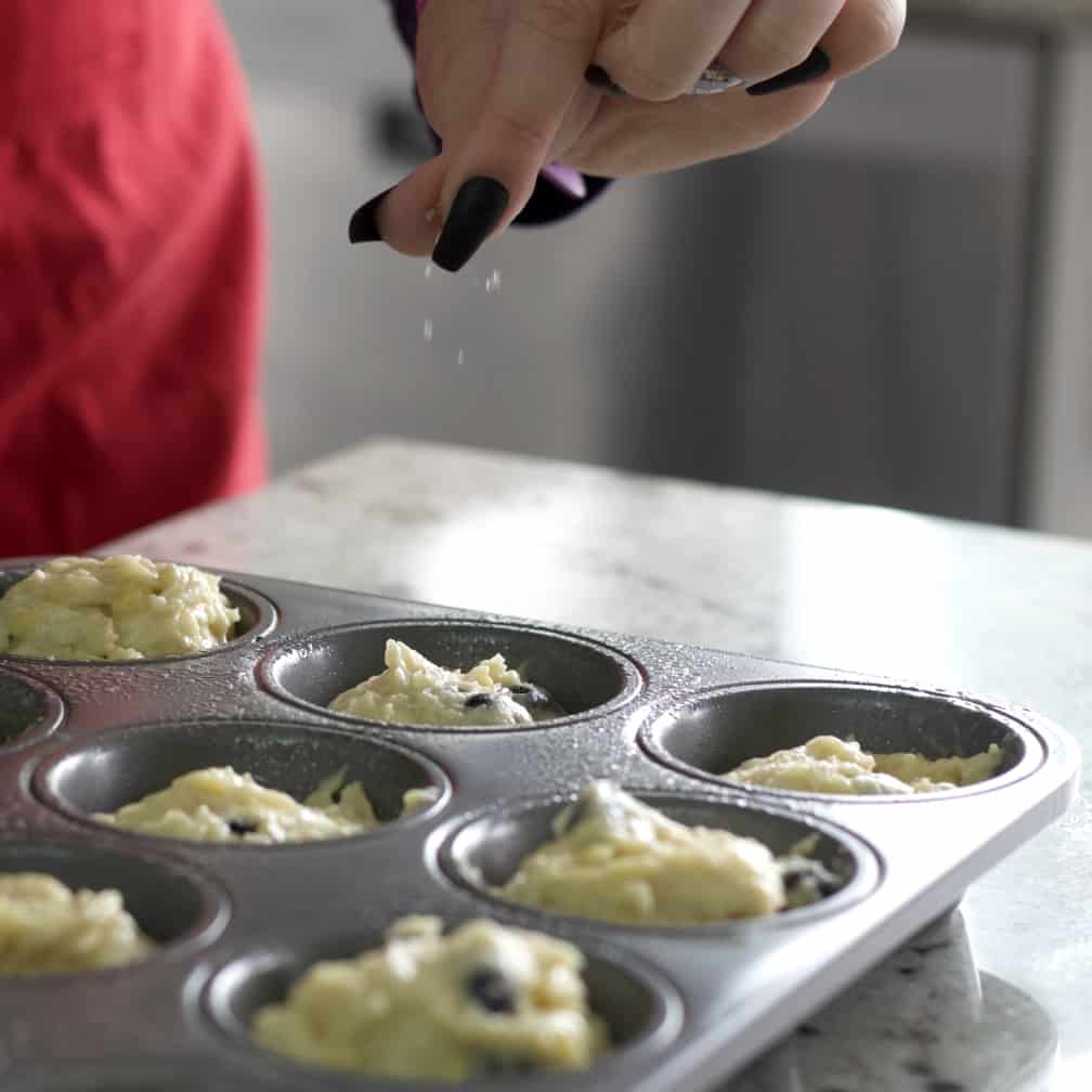 Incredible Banana Blueberry Muffins 18 sprinkling sanding sugar over banana muffins