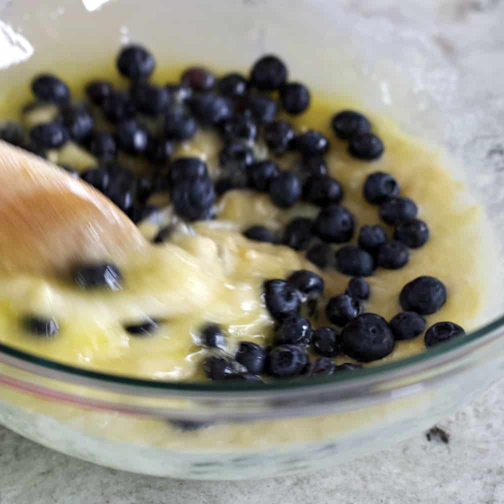 Incredible Banana Blueberry Muffins 10 stirring in blueberries