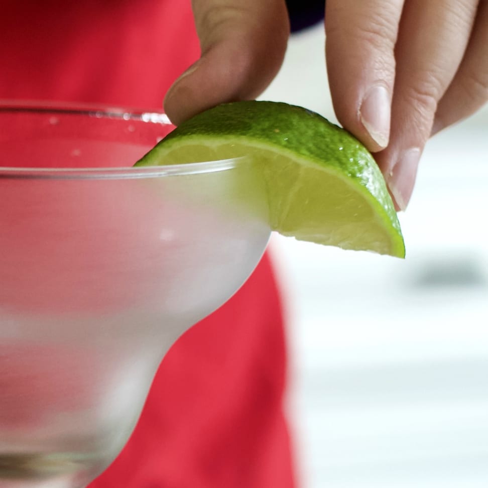 Cadillac Margarita Recipe with Grand Marnier 9 lime wedge wetting a margarita glass rim
