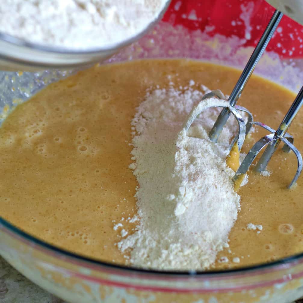 adding dry ingredients into batter