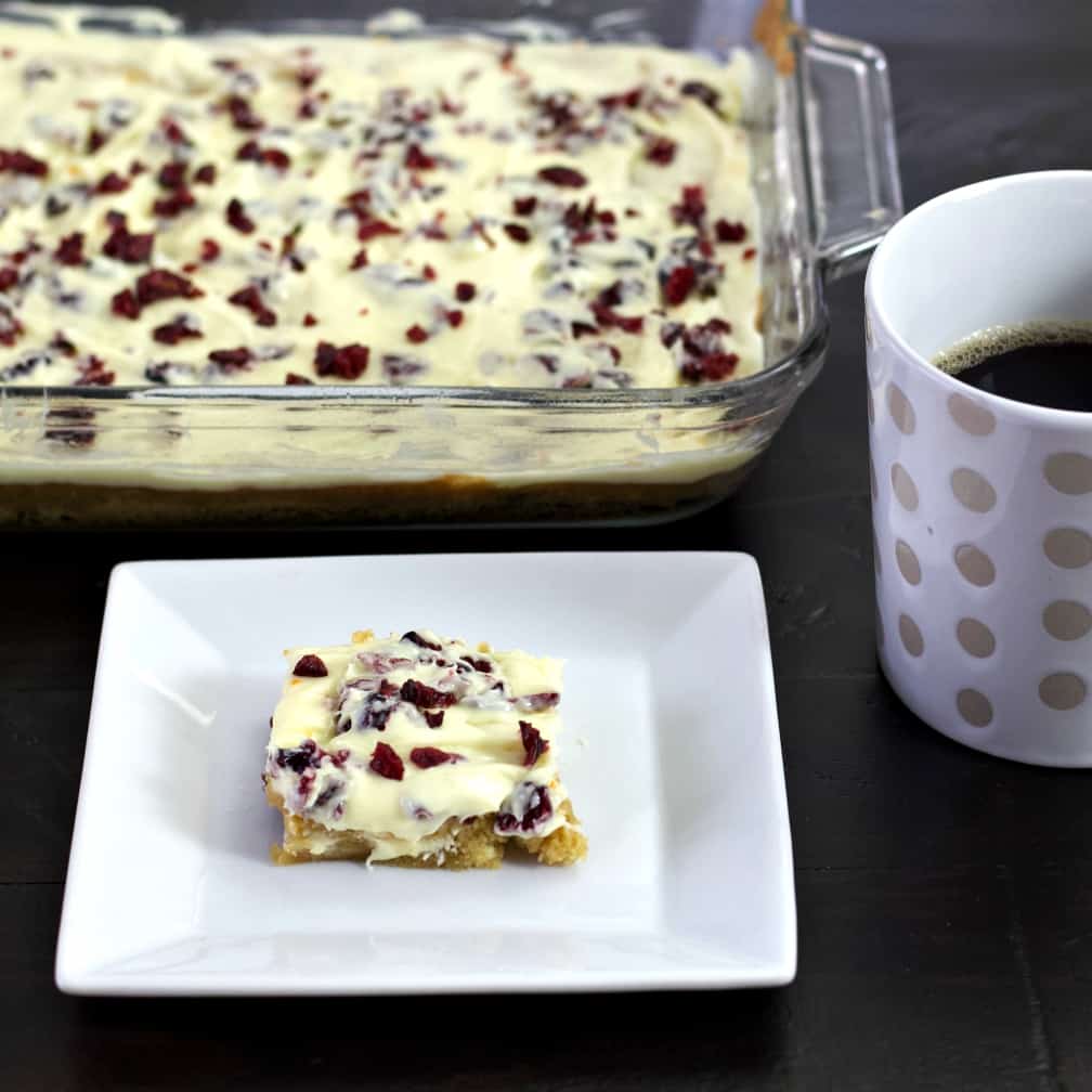 cranberry bliss bar with coffee and panful
