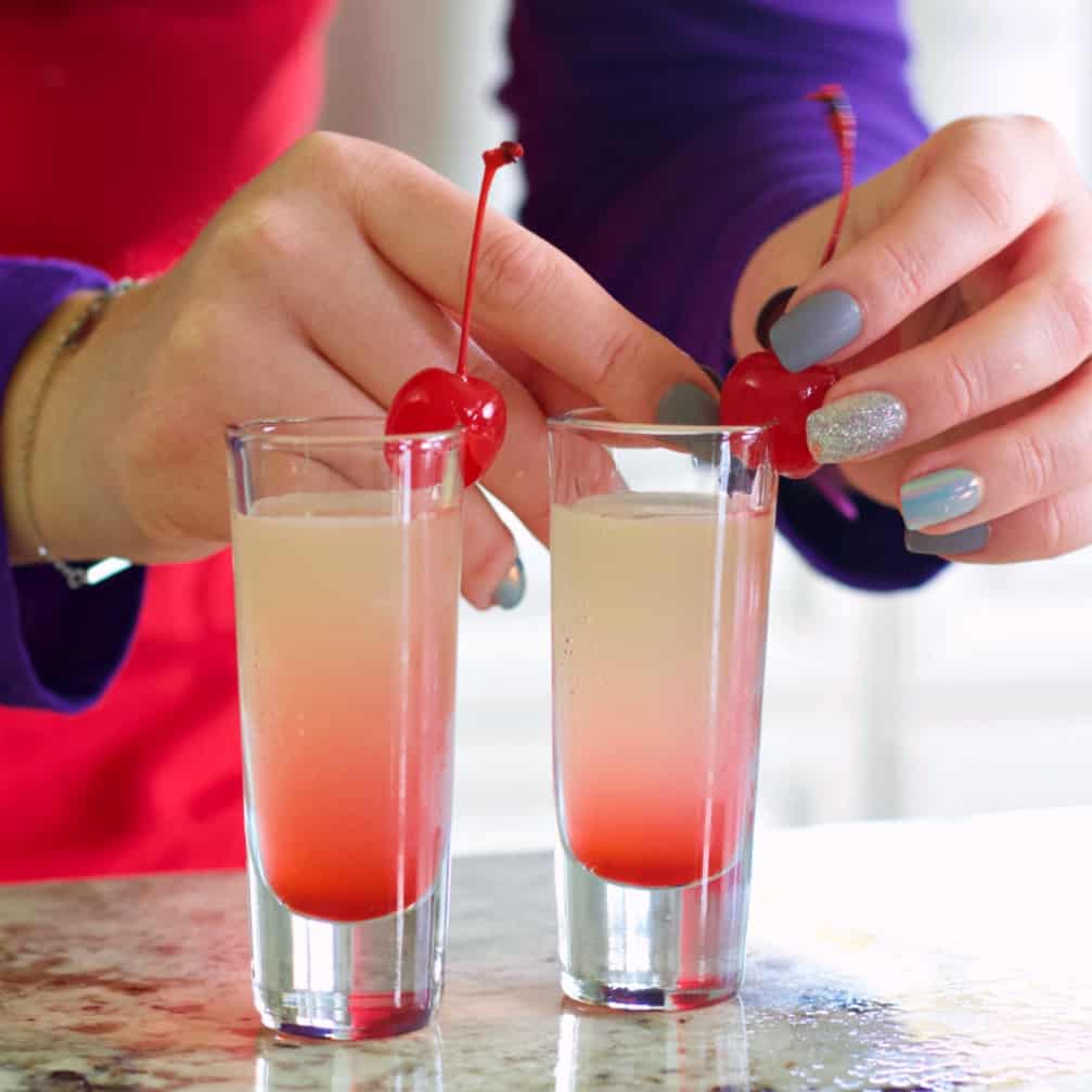 garnishing the pineapple upside down cake shots
