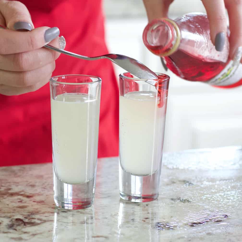 pouring grenadine over a spoon back