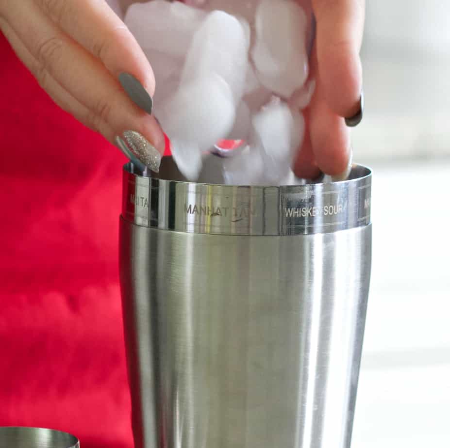 pouring ice in a cocktail shaker