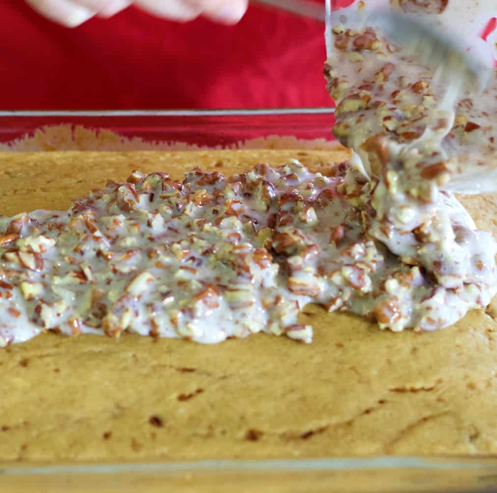 pouring glaze on warm sweet potato cake