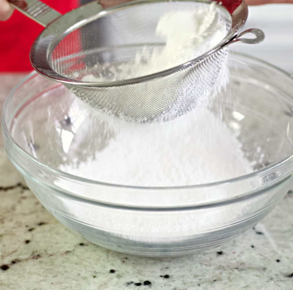 sifting powdered sugar-frosting for bliss bars