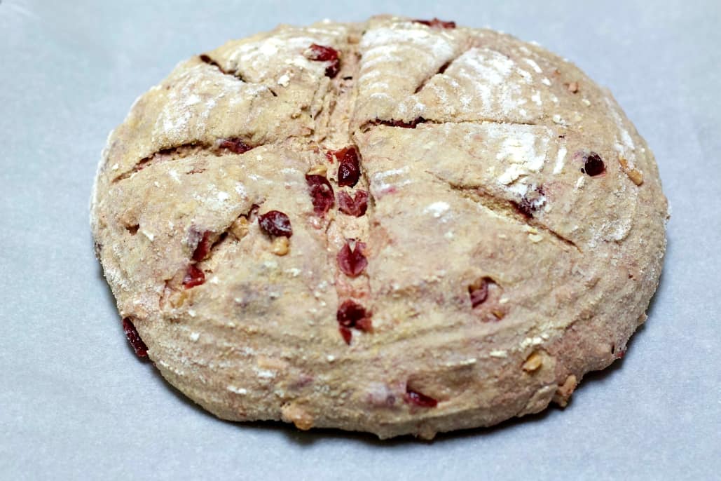 scored loaf of cranberry walnut bread
