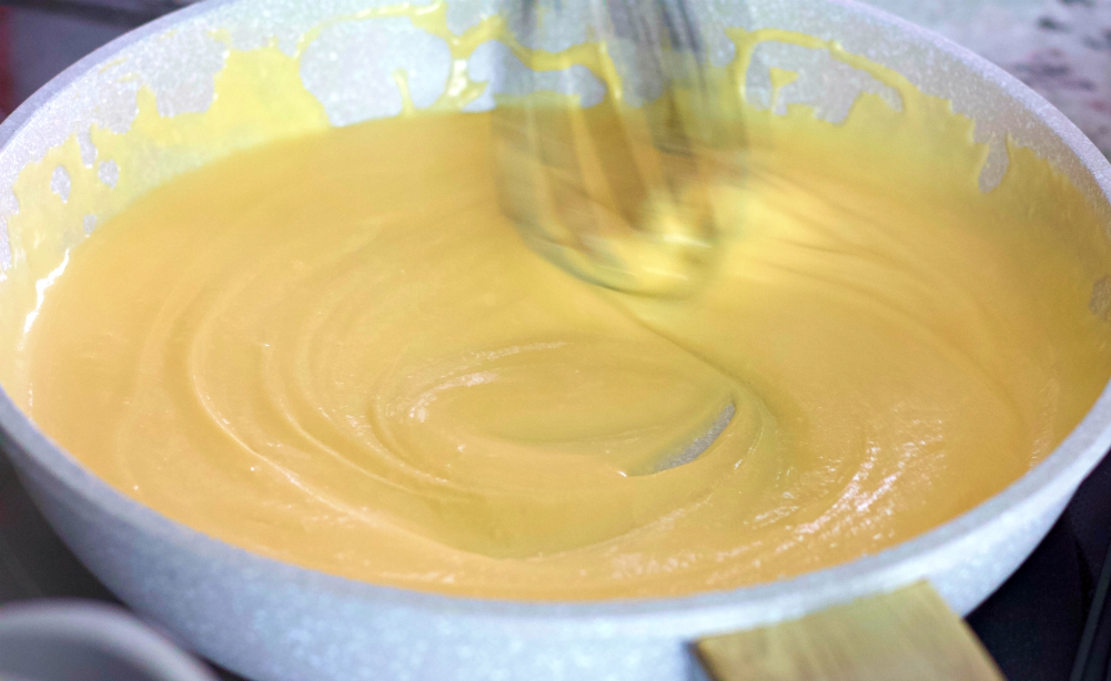 whisking cheese sauce