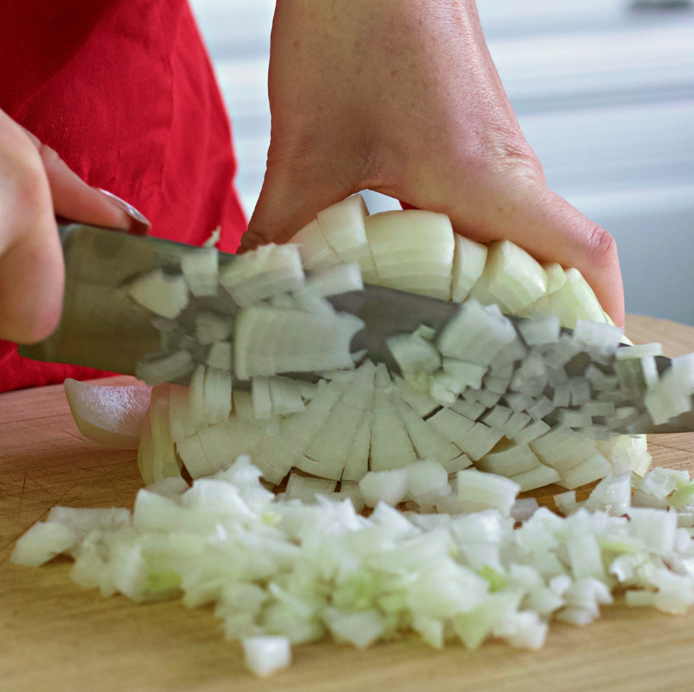 dicing onion-egg rolls in a bowl